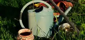 white and brown watering can on green grass