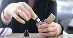 person holding silver flip lighter